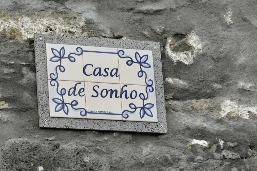 Azulejo tile sign reading Casa de Sonho set into a basalt wall